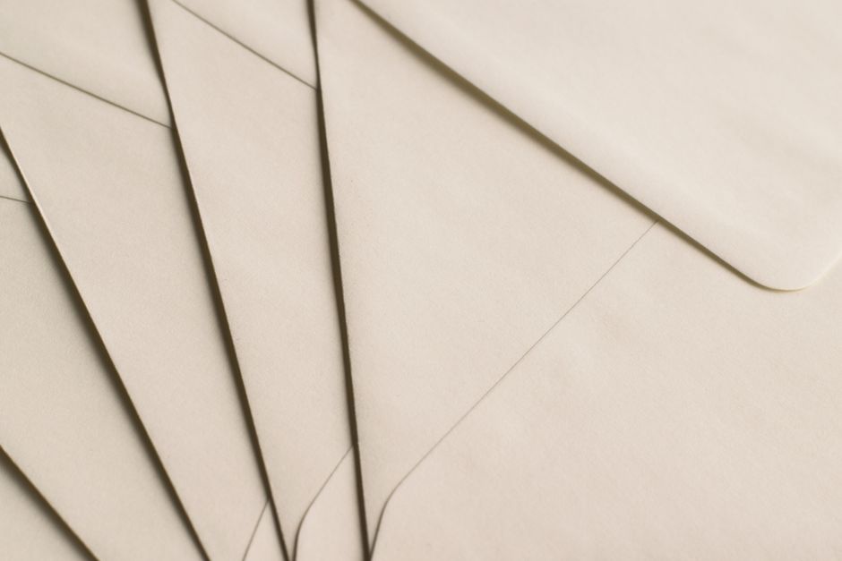 A close-up photo of beige envelopes arranged on a neutral background, ideal for stationery themes.